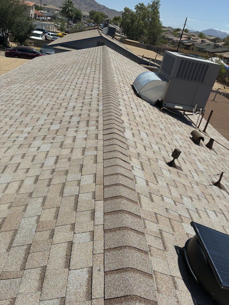 Finished shingle roof ridge with the Phoenix mountains in the distance