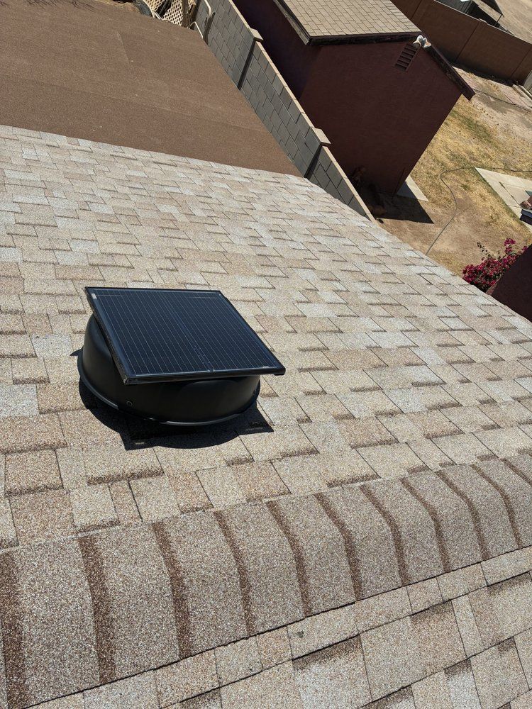 A recently completed Phoenix shingle roof with a solar attic fan