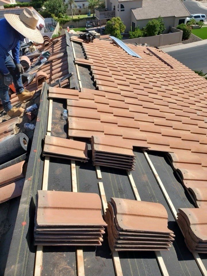 Third Gen crew re-felting the underlayment beneath an existing tile roof